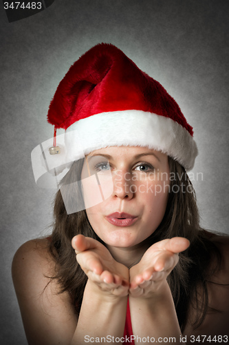 Image of Portrait kissing Santa Woman