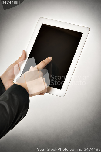 Image of business woman points tablet computer