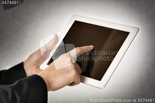 Image of business woman points tablet computer