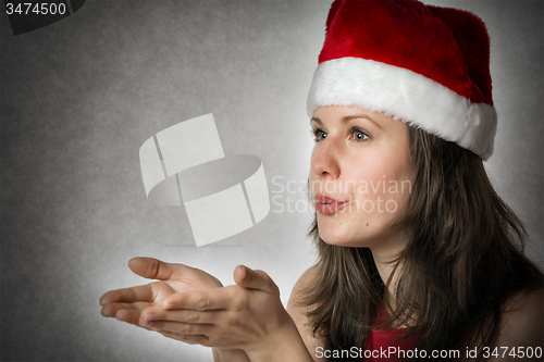 Image of Portrait kissing Santa Woman