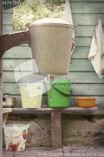 Image of rustic washstand attach to a wooden walll