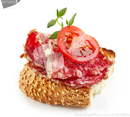 Image of toasted bread with salami and tomato