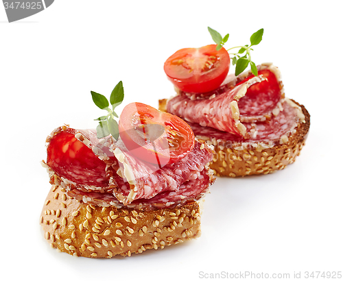 Image of toasted bread with salami and tomato