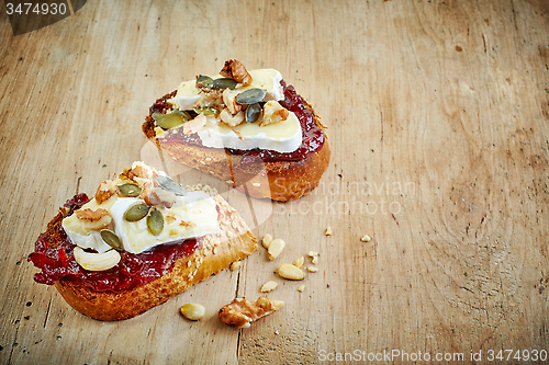 Image of toasted bread slices with jam and brie cheese