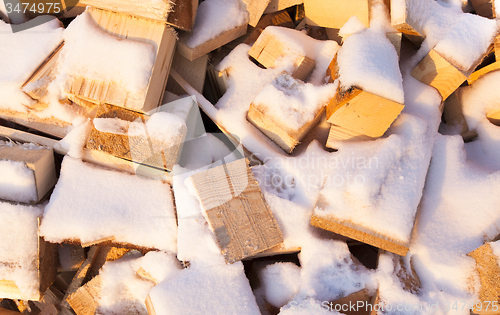 Image of firewood under snow  