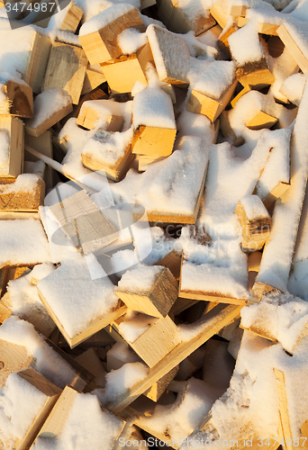 Image of firewood under snow  