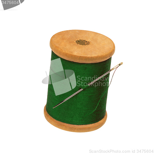 Image of Spool of thread and needle isolated