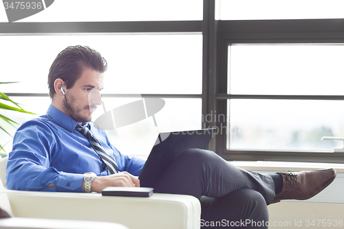 Image of Businessman in office working on his laptop. 