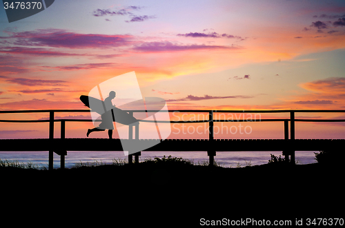 Image of Surfer running to the beach