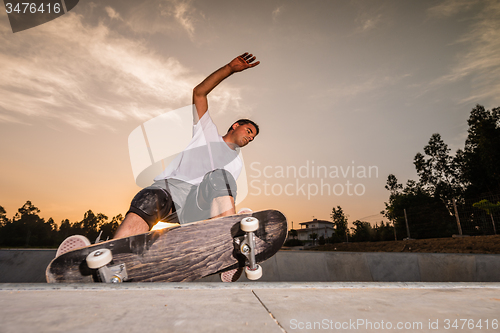 Image of Skateboarder in a concrete pool 