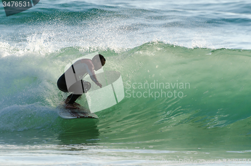 Image of Long boarder surfing the waves at sunset