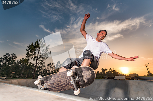 Image of Skateboarder in a concrete pool 