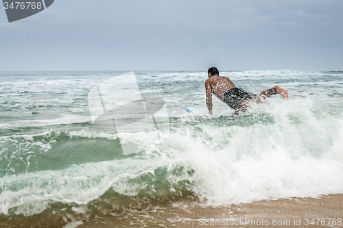 Image of Surfer entering the water