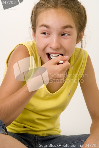 Image of Girl eating yoghurt VI