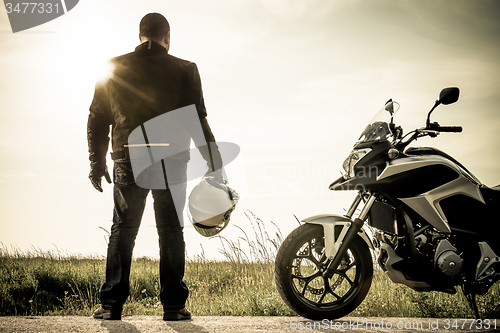 Image of Biker on a misty sunset