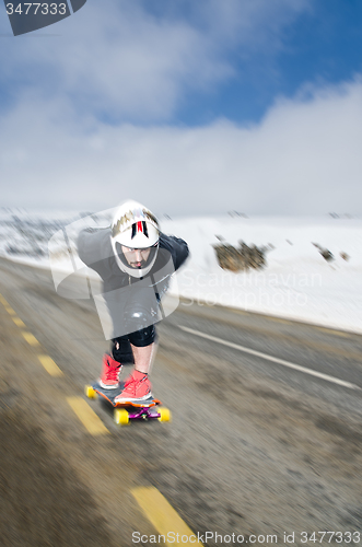 Image of Downhill skateboarder in action