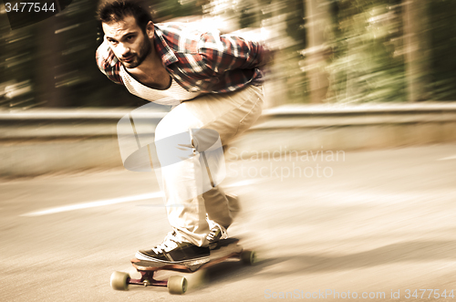 Image of Downhill skateboarder in action