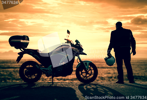 Image of Biker on a misty sunset