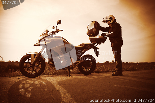 Image of Biker on a misty sunset