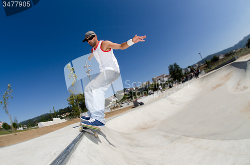 Image of Skateboarder in a concrete pool 