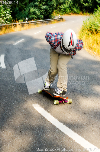 Image of Downhill skateboarder in action