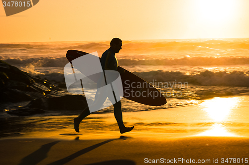 Image of Surfer running