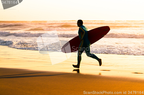 Image of Surfer running