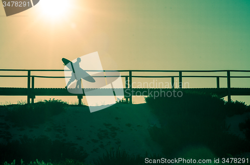 Image of Surfer running to the beach