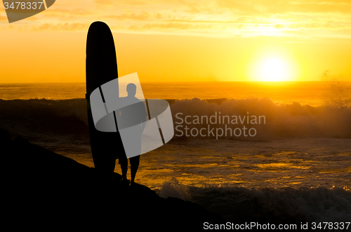 Image of Long boarder watching the waves