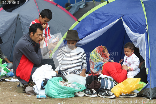 Image of Syrian refugees resting in tent