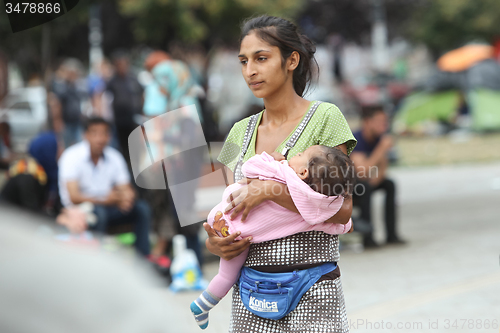 Image of Syrian refugee woman with child in Belgrade