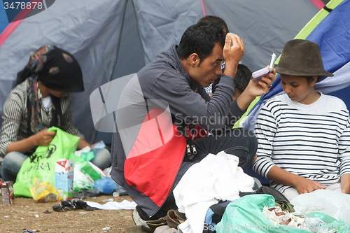 Image of Man fixing his hair 