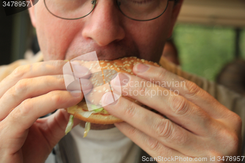 Image of Man eating a hamburger