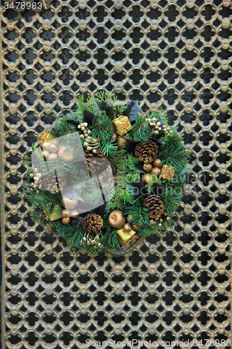 Image of Classic christmas wreath with decorations on a door