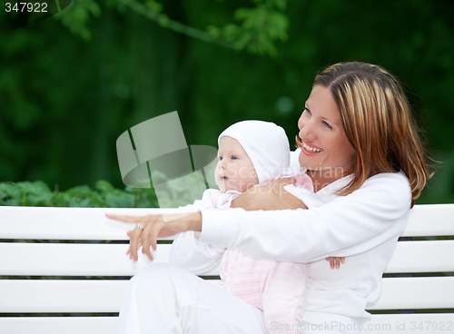 Image of happy mother with baby on the bench