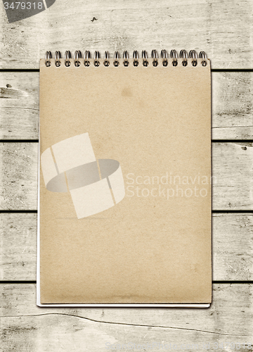 Image of Closed spiral Note book on a white wood table