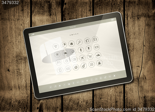 Image of Digital tablet PC on a dark wood table