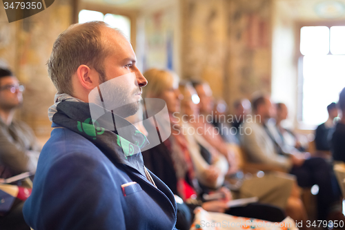 Image of Entrepreneur in audience at business conference.