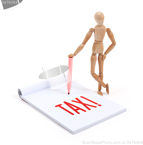 Image of Wooden mannequin writing - Tax