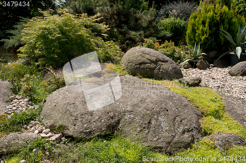 Image of Beautiful spring garden design with stones