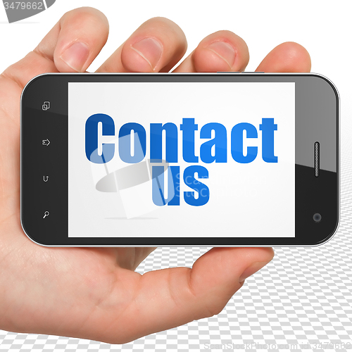 Image of Advertising concept: Hand Holding Smartphone with Contact Us on display