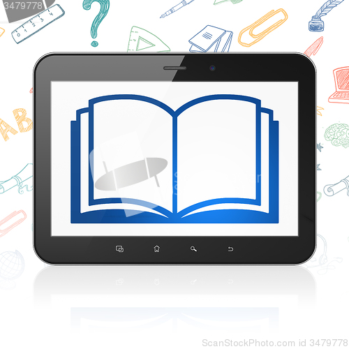 Image of Studying concept: Tablet Computer with Book on display