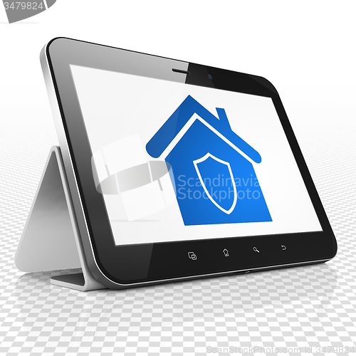 Image of Finance concept: Tablet Computer with Home on display