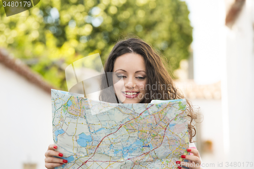 Image of Beautiful tourist searching on the map