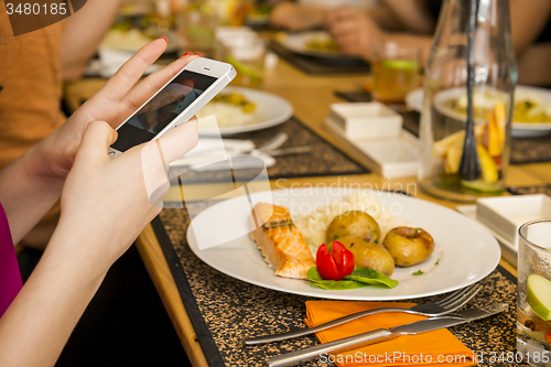 Image of Taking a picture of the food