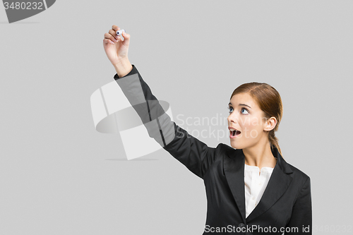 Image of Businesswoman drawing on a glass board