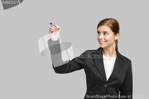 Image of Businesswoman drawing on a glass board