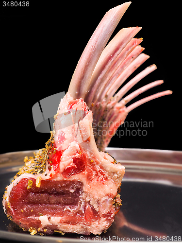 Image of Rack of lamb seasoned on a silver plate