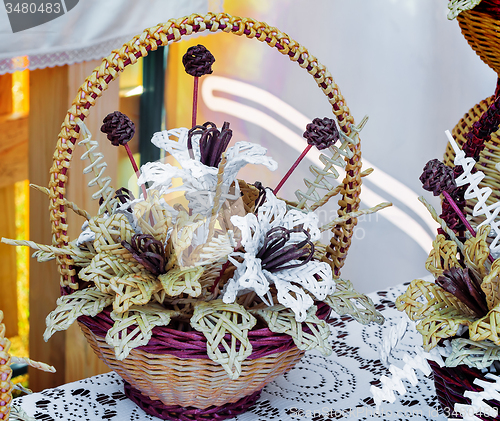 Image of Original Souvenirs of woven straw are sold at the fair.