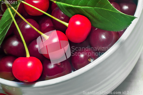Image of Big ripe cherry in a ceramic vase.